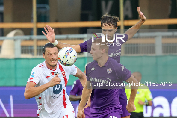 Pietro Comuzzo of ACF Fiorentina and Milan Djuric of AC Monza battle for the ball during the Italian Serie A football match between ACF Fior...