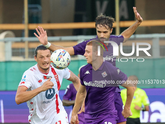 Pietro Comuzzo of ACF Fiorentina and Milan Djuric of AC Monza battle for the ball during the Italian Serie A football match between ACF Fior...