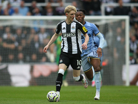 Newcastle United's Anthony Gordon breaks away from Tottenham Hotspur's Destiny Udogie during the Premier League match between Newcastle Unit...