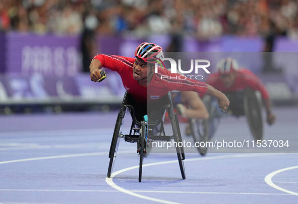 Pongsakorn Paeyo of Thailand celebrates winning gold in Men's 400m - T53 Final during the Paris 2024 Paralympic Games at Stade de France on...