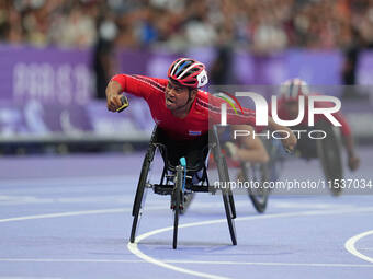 Pongsakorn Paeyo of Thailand celebrates winning gold in Men's 400m - T53 Final during the Paris 2024 Paralympic Games at Stade de France on...