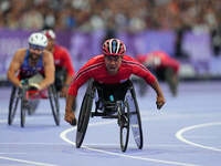 Pongsakorn Paeyo of Thailand celebrates winning gold in Men's 400m - T53 Final during the Paris 2024 Paralympic Games at Stade de France on...