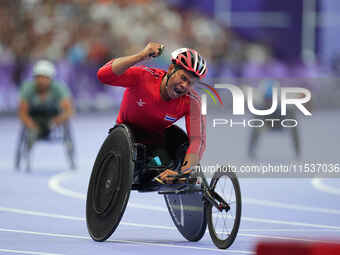 Pongsakorn Paeyo of Thailand celebrates winning gold in Men's 400m - T53 Final during the Paris 2024 Paralympic Games at Stade de France on...