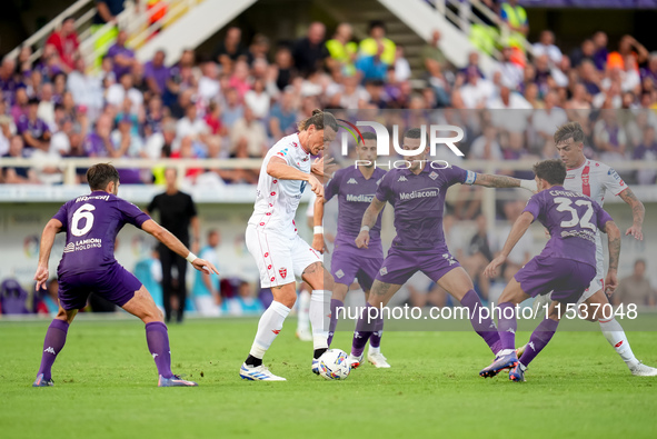 Milan Djuric of AC Monza is challenged by Cristiano Biraghi of ACF Fiorentina during the Serie A Enilive match between ACF Fiorentina and AC...