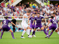 Milan Djuric of AC Monza is challenged by Cristiano Biraghi of ACF Fiorentina during the Serie A Enilive match between ACF Fiorentina and AC...