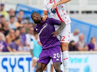 Pablo Mari' of AC Monza and Moise Kean of ACF Fiorentina jump for the ball during the Serie A Enilive match between ACF Fiorentina and AC Mo...