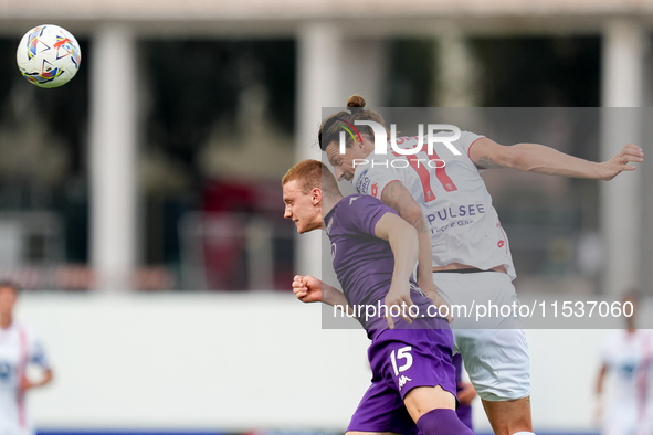 Milan Djuric of AC Monza and Pietro Comuzzo of ACF Fiorentina jump for the ball during the Serie A Enilive match between ACF Fiorentina and...