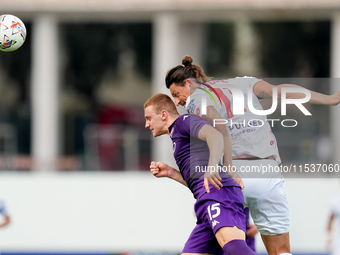 Milan Djuric of AC Monza and Pietro Comuzzo of ACF Fiorentina jump for the ball during the Serie A Enilive match between ACF Fiorentina and...