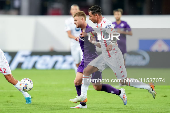 Lucas Beltran of ACF Fiorentina and Armando Izzo of AC Monza compete for the ball during the Serie A Enilive match between ACF Fiorentina an...