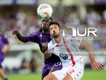 Moise Kean of ACF Fiorentina and Pablo Mari' of AC Monza compete for the ball during the Serie A Enilive match between ACF Fiorentina and AC...