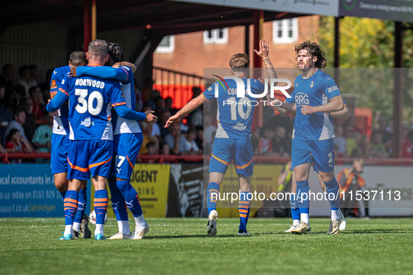 Oldham players celebrate after James Norwood's goal during the Vanarama National League match between Altrincham and Oldham Athletic at Moss...