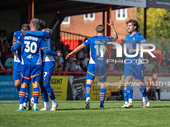 Oldham players celebrate after James Norwood's goal during the Vanarama National League match between Altrincham and Oldham Athletic at Moss...