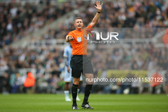 Referee Robert Jones officiates the Premier League match between Newcastle United and Tottenham Hotspur at St. James's Park in Newcastle, Un...