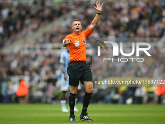 Referee Robert Jones officiates the Premier League match between Newcastle United and Tottenham Hotspur at St. James's Park in Newcastle, Un...