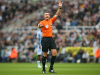 Referee Robert Jones officiates the Premier League match between Newcastle United and Tottenham Hotspur at St. James's Park in Newcastle, Un...