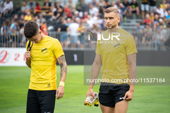 Dawid Kiedrowicz and Michal Feliks stand before the game between Wieczysta Krakow and Pogon Grodzisk Mazowiecki in Krakow, Poland, on Septem...