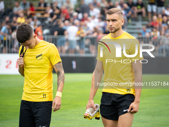 Dawid Kiedrowicz and Michal Feliks stand before the game between Wieczysta Krakow and Pogon Grodzisk Mazowiecki in Krakow, Poland, on Septem...