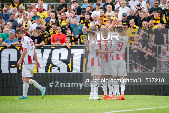 Pogon players celebrate scoring a goal in a game between Wieczysta Krakow and Pogon Grodzisk Mazowiecki in Krakow, Poland, on September 1, 2...