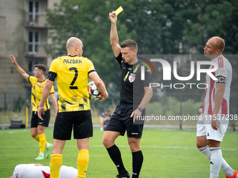 Referee Tomasz Wajda shows a yellow card to Michal Pazdan during a game between Wieczysta Krakow and Pogon Grodzisk Mazowiecki in Krakow, Po...