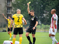 Referee Tomasz Wajda shows a yellow card to Michal Pazdan during a game between Wieczysta Krakow and Pogon Grodzisk Mazowiecki in Krakow, Po...