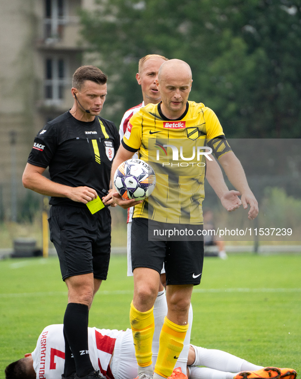 Referee Tomasz Wajda shows a yellow card to Michal Pazdan during a game between Wieczysta Krakow and Pogon Grodzisk Mazowiecki in Krakow, Po...