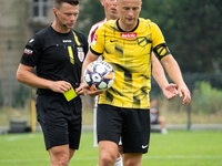 Referee Tomasz Wajda shows a yellow card to Michal Pazdan during a game between Wieczysta Krakow and Pogon Grodzisk Mazowiecki in Krakow, Po...