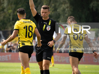 Referee Tomasz Wajda shows a yellow card to Manuel Torres during a game between Wieczysta Krakow and Pogon Grodzisk Mazowiecki in Krakow, Po...