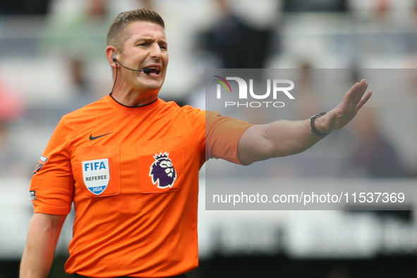 Referee Robert Jones officiates the Premier League match between Newcastle United and Tottenham Hotspur at St. James's Park in Newcastle, En...