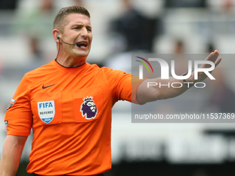 Referee Robert Jones officiates the Premier League match between Newcastle United and Tottenham Hotspur at St. James's Park in Newcastle, En...