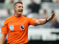 Referee Robert Jones officiates the Premier League match between Newcastle United and Tottenham Hotspur at St. James's Park in Newcastle, En...