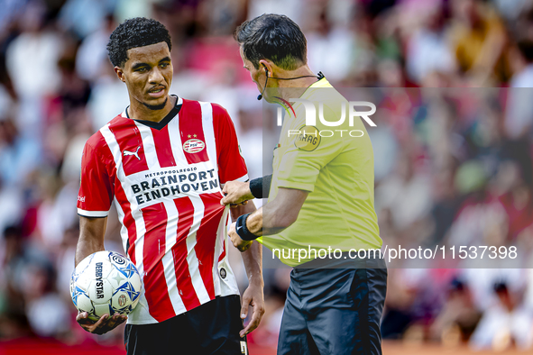 PSV player Malik Tillman and referee Bas Nijhuis during the match between PSV and Go Ahead Eagles at the Philips Stadium for the Dutch Eredi...