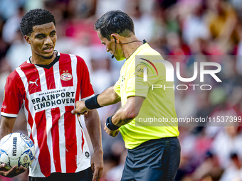 PSV player Malik Tillman and referee Bas Nijhuis during the match between PSV and Go Ahead Eagles at the Philips Stadium for the Dutch Eredi...