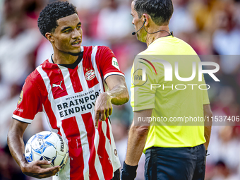 PSV player Malik Tillman and referee Bas Nijhuis during the match between PSV and Go Ahead Eagles at the Philips Stadium for the Dutch Eredi...