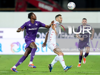 Cristian Kouame of ACF Fiorentina and Roberto Gagliardini of AC Monza compete for the ball during the Serie A Enilive match between ACF Fior...