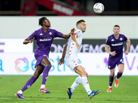 Cristian Kouame of ACF Fiorentina and Roberto Gagliardini of AC Monza compete for the ball during the Serie A Enilive match between ACF Fior...