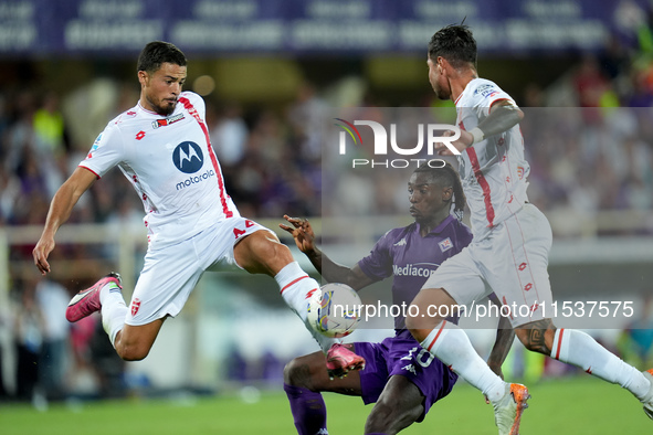 Andrea Carboni of AC Monza and Moise Kean of ACF Fiorentina compete for the ball during the Serie A Enilive match between ACF Fiorentina and...