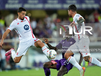 Andrea Carboni of AC Monza and Moise Kean of ACF Fiorentina compete for the ball during the Serie A Enilive match between ACF Fiorentina and...