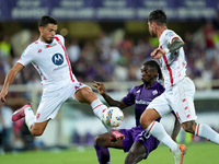 Andrea Carboni of AC Monza and Moise Kean of ACF Fiorentina compete for the ball during the Serie A Enilive match between ACF Fiorentina and...