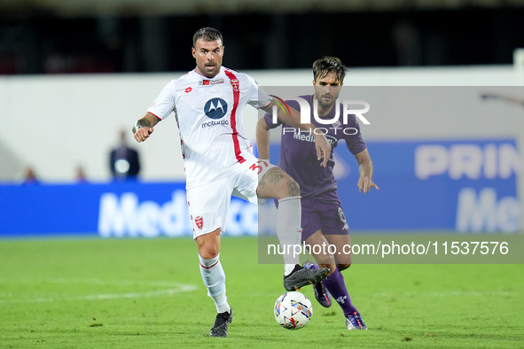 Luca Ranieri of ACF Fiorentina and Andrea Petagna of AC Monza compete for the ball during the Serie A Enilive match between ACF Fiorentina a...