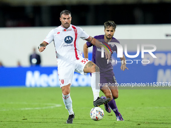 Luca Ranieri of ACF Fiorentina and Andrea Petagna of AC Monza compete for the ball during the Serie A Enilive match between ACF Fiorentina a...