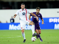 Luca Ranieri of ACF Fiorentina and Andrea Petagna of AC Monza compete for the ball during the Serie A Enilive match between ACF Fiorentina a...