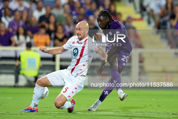 Moise Kean of ACF Fiorentina and Luca Caldirola of AC Monza during the Serie A Enilive match between ACF Fiorentina and AC Monza at Stadio A...