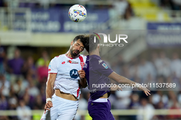 Pablo Mari' of AC Monza and Luca Ranieri of ACF Fiorentina jump for the ball during the Serie A Enilive match between ACF Fiorentina and AC...