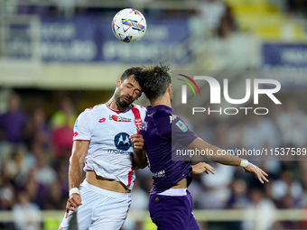 Pablo Mari' of AC Monza and Luca Ranieri of ACF Fiorentina jump for the ball during the Serie A Enilive match between ACF Fiorentina and AC...