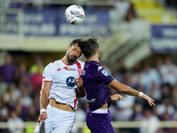 Pablo Mari' of AC Monza and Luca Ranieri of ACF Fiorentina jump for the ball during the Serie A Enilive match between ACF Fiorentina and AC...