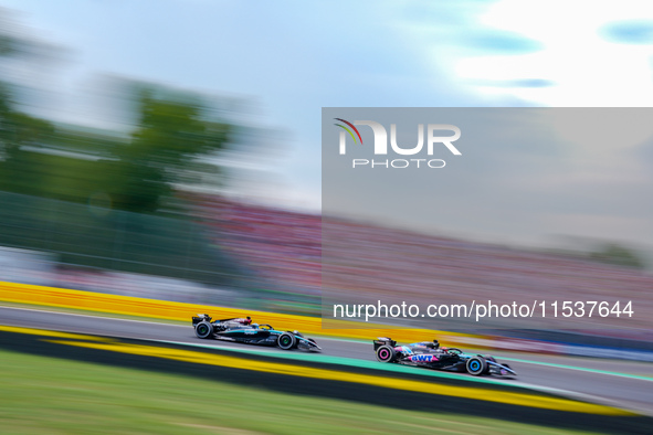 Esteban Ocon of France drives the (31) BWT Alpine F1 Team A524 and George Russell of the United Kingdom drives the (63) Mercedes-AMG PETRONA...