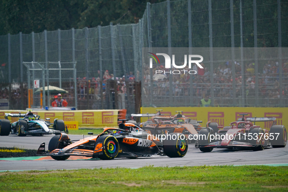 Oscar Piastri of Australia drives the (81) McLaren F1 Team MCL38 and Charles Leclerc of Monaco drives the (16) Scuderia Ferrari SF-24 during...