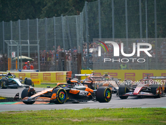 Oscar Piastri of Australia drives the (81) McLaren F1 Team MCL38 and Charles Leclerc of Monaco drives the (16) Scuderia Ferrari SF-24 during...