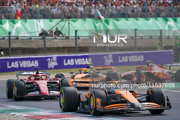 Oscar Piastri of Australia drives the (81) McLaren F1 Team MCL38 and Charles Leclerc of Monaco drives the (16) Scuderia Ferrari SF-24 during...