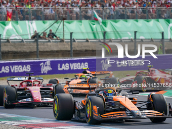 Oscar Piastri of Australia drives the (81) McLaren F1 Team MCL38 and Charles Leclerc of Monaco drives the (16) Scuderia Ferrari SF-24 during...